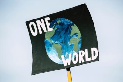 One Word protest sign with image of the earth
