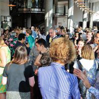 Busy room full of industry professionals chatting