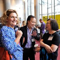 4 professionals engage in friendly conversation