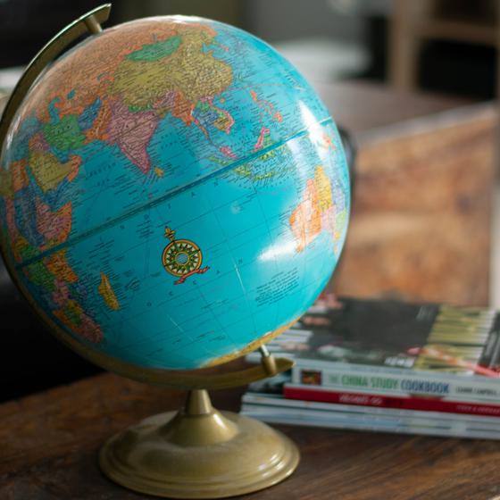 Globe on a table in front of a small stack of books